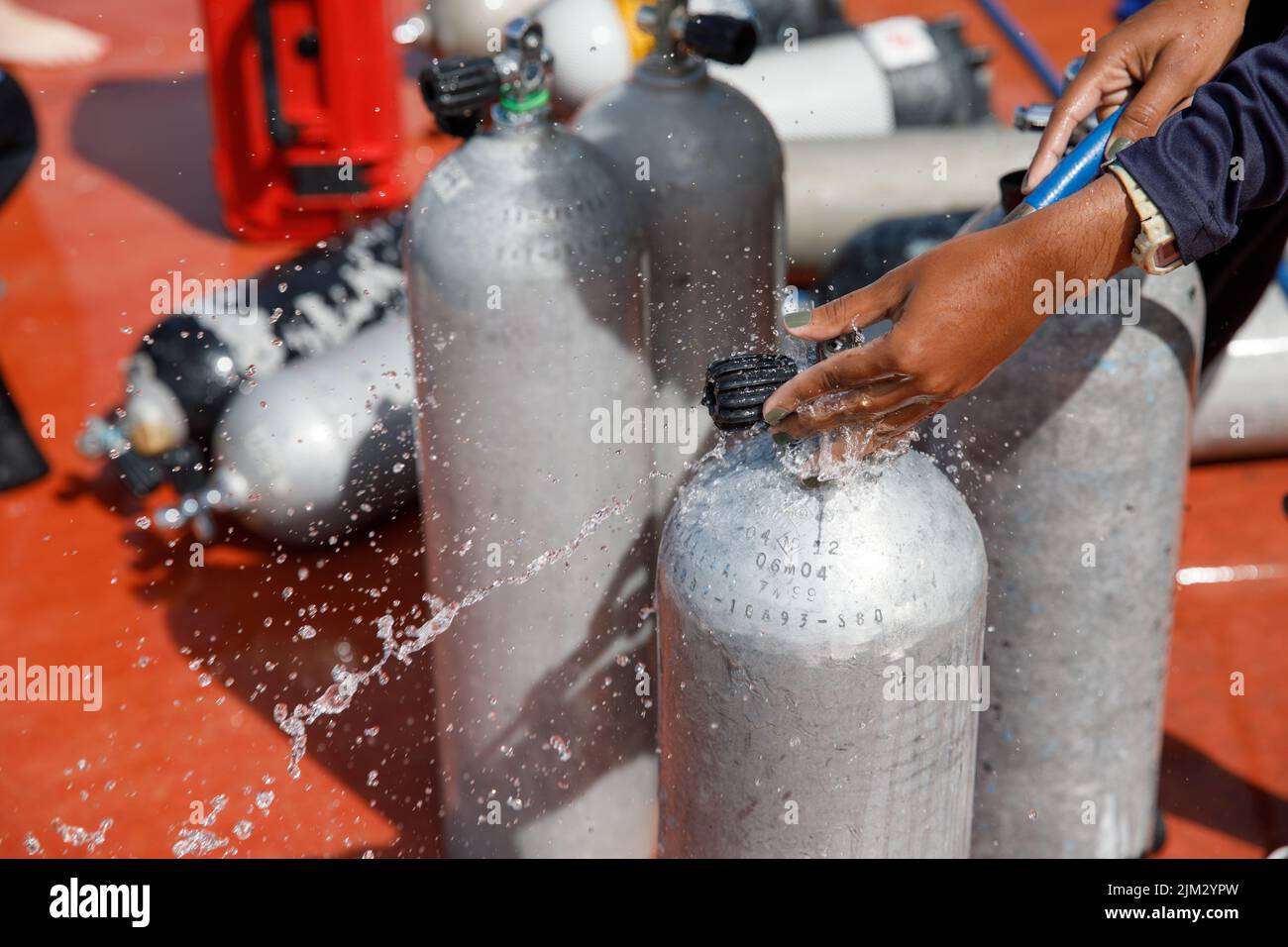 Close-up of scuba diving tanks on a tropical beach in Mexico. In the background the Caribbean Sea. Refueling diving cylinders. Stock Photo