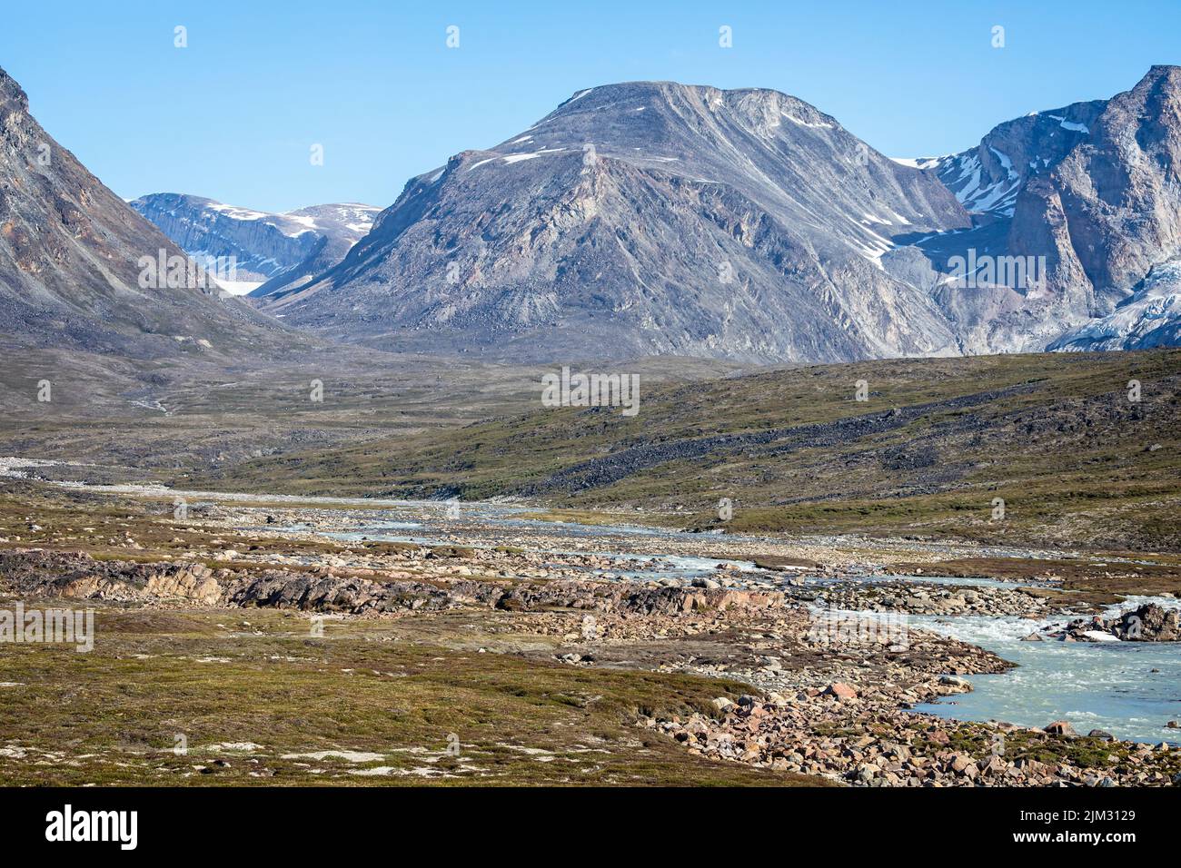Landscape of mountains and meltwater river at Camp Frieda on the Disko Bay coast, Greenland on 18 July 2022 Stock Photo