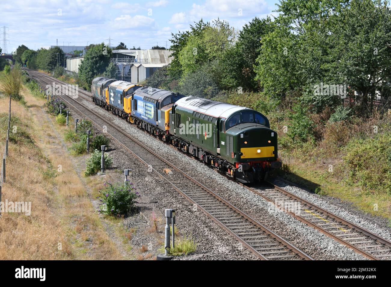 BR Green liveried English Electric Class 37 diesel locomotive number D6817 (37521) hauling sister locos 37259, 37409 and 37038 from Crewe to Worksop Stock Photo