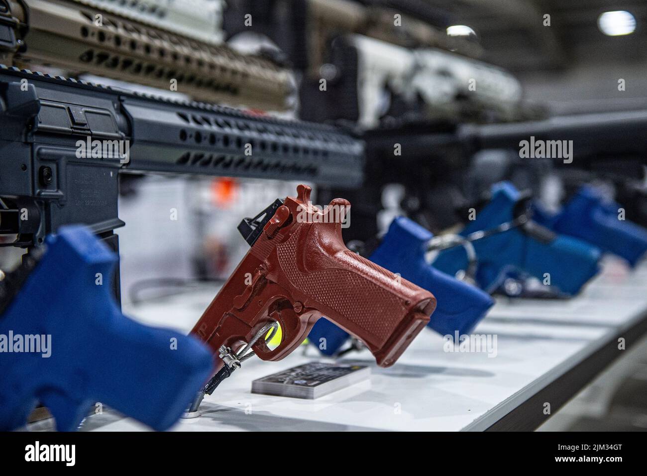 handguns and machine guns for sale at an arms fair Stock Photo