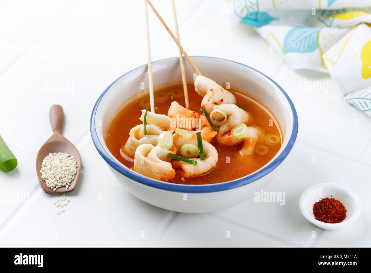 Eomukguk or Odeng Soup, Korean Popular Street Food Made from Fish Cake Eomuk and Spicy Gochujang Paste. On White Table Stock Photo