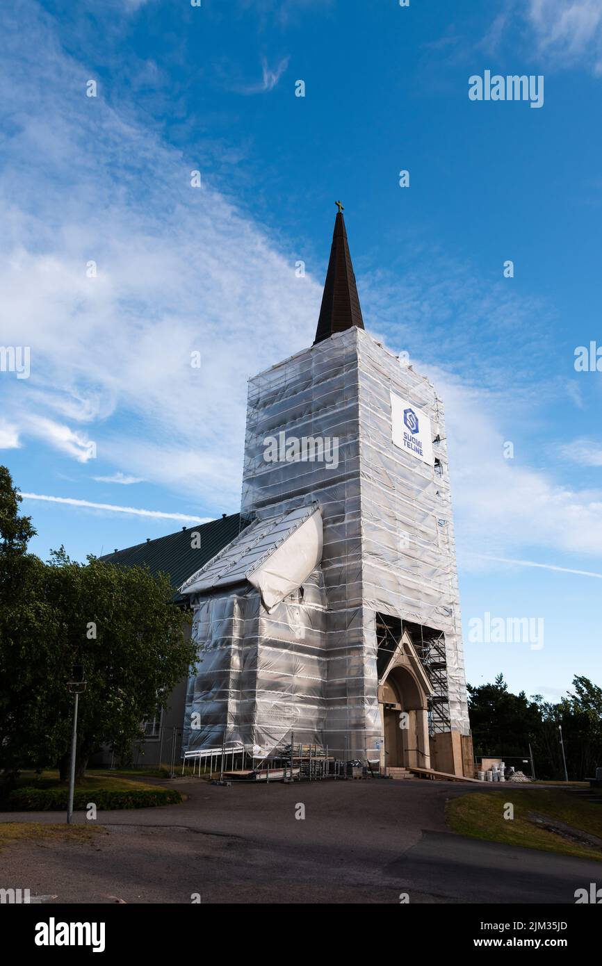 Hanko, Finland. July 16, 2022. Hanko Church under renovation with scaffolding and protective sheeting around the tower Stock Photo