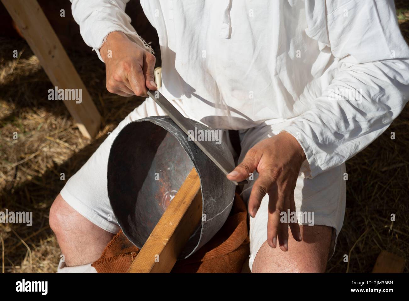 Italy, Lombardy, Historical Reenactment Medieval, Artisan Creates Metal Helmet Stock Photo