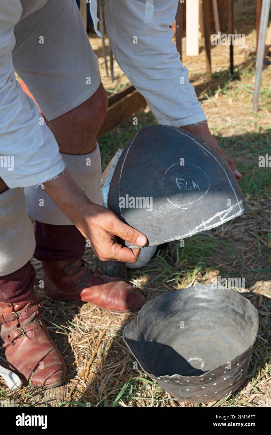 Italy, Lombardy, Historical Reenactment Medieval, Artisan Creates Metal Helmet Stock Photo
