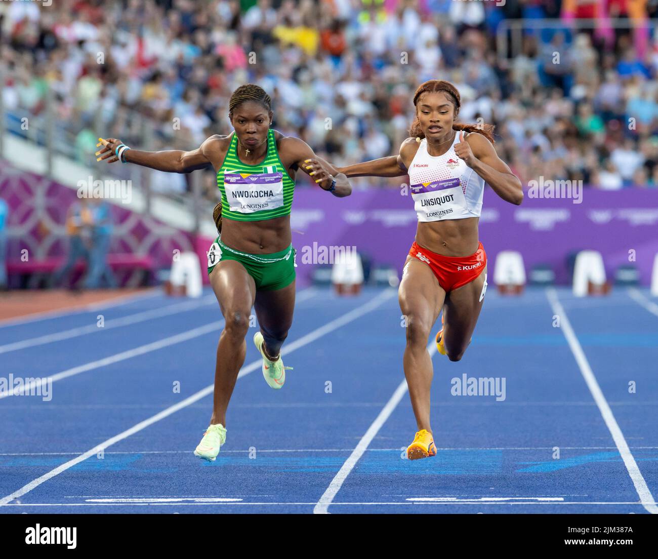 3rd August 2022; Alexander Stadium, Birmingham, Midlands, England: Day 6 of the 2022 Commonwealth Games: Nzubechi Grace Nwokocha (NGR) dips for the finish line to come second place in the Women's 100m Semi-Final 1 alongside Imani Lansiquot (ENG) who came in third place Stock Photo