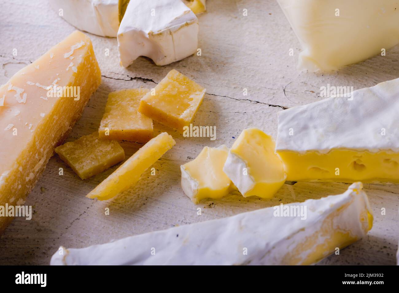 High angle view of various cheese on wooden table, copy space. unaltered, food and dairy product. Stock Photo