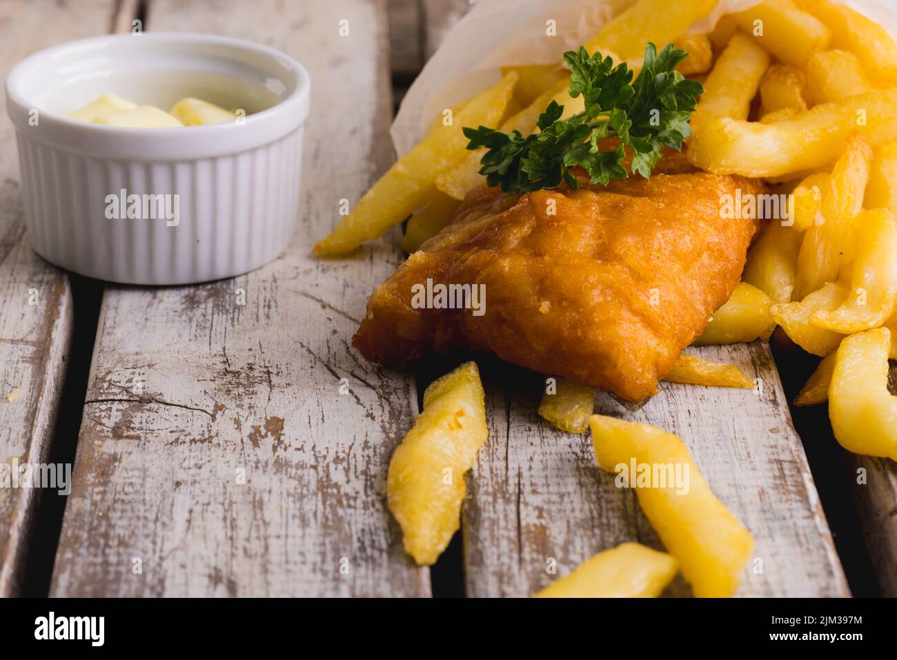 Close-up of french fries with seafood and sauce on wooden table, copy space Stock Photo