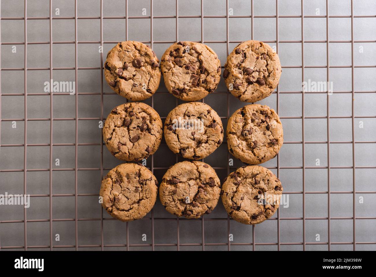 Directly above view of fresh cookies on cooling rack at table, copy space Stock Photo