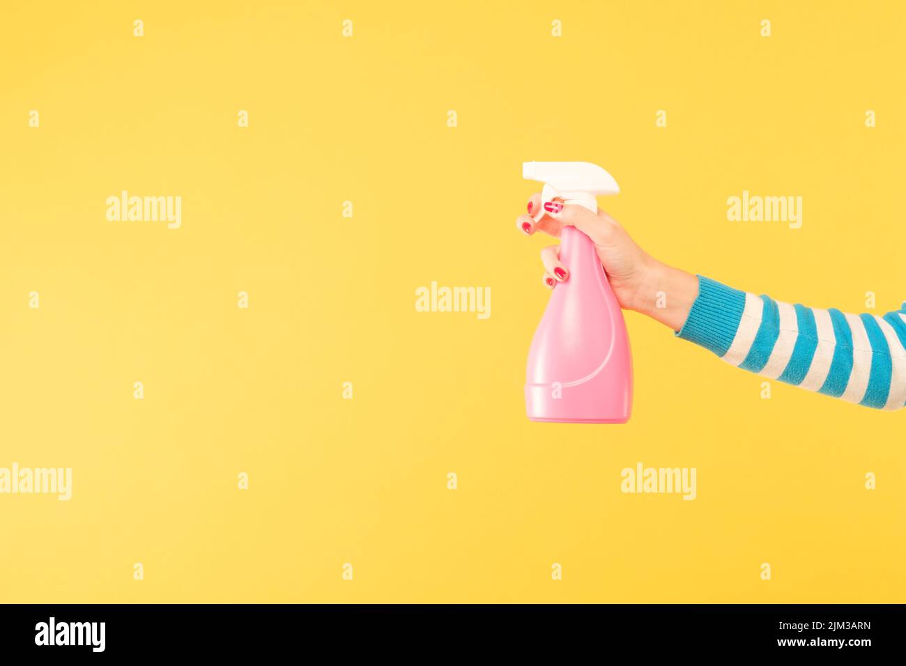 female hand hold sprayer yellow cleaning housework Stock Photo