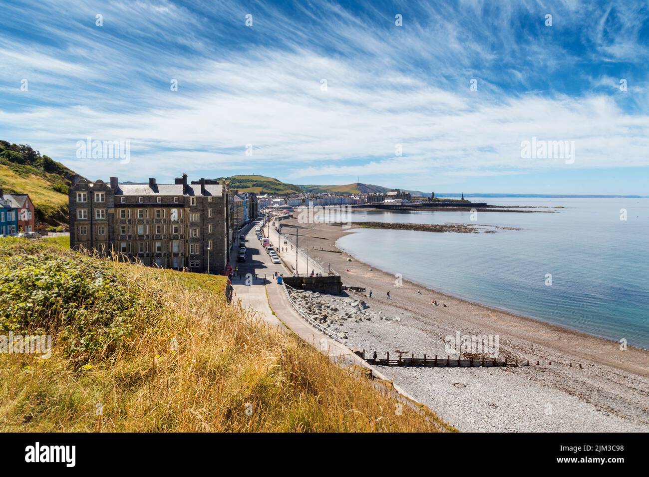 A view along the promenade and pebble beach at Aberystwyth, Wales. Stock Photo