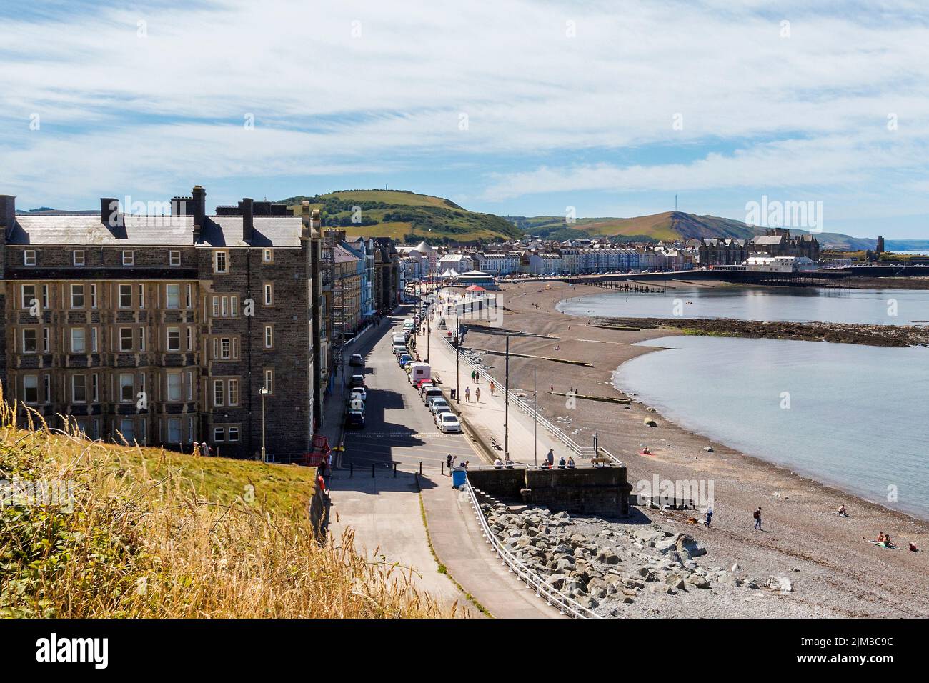 A view along the promenade and pebble beach at Aberystwyth, Wales. Stock Photo