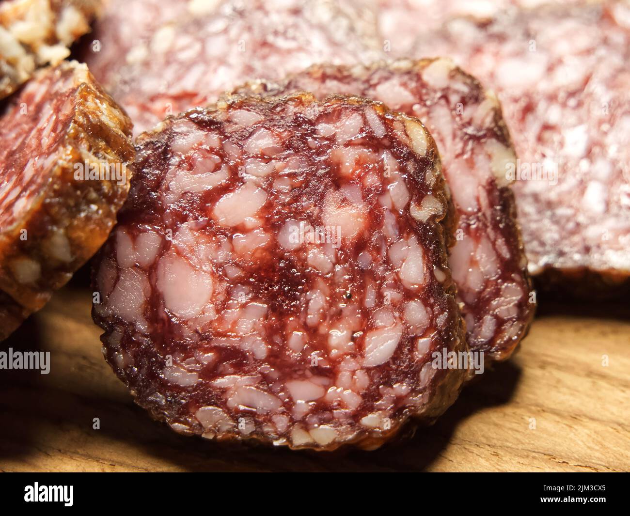 Dried sausage, close-up shot. Lots of sausage slices. Stock Photo