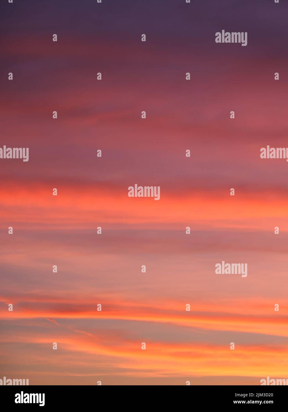 Vibrant and Colorful Sunset background. Bright sunset sky, full frame. The sky as a background. Stock Photo