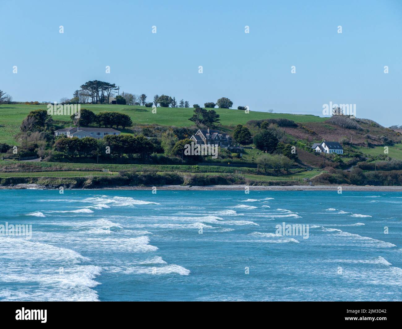 Picturesque Clonakilty Bay on a sunny day. Beautiful nature of southern Ireland. Blue waters of the Atlantic Ocean under a clear sky. Coastal landscap Stock Photo