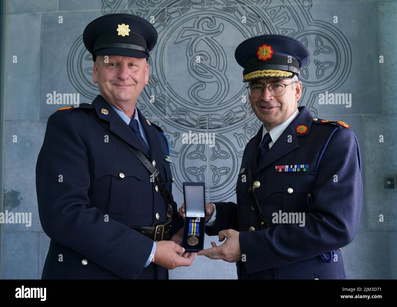 Garda Commissioner Drew Harris (right) with Inspector Dick Fahey of the Special Tactics and Operations Command at a ceremony held by An Garda Síochána, as part of their Centenary Commemorations, to present serving and retired Garda personnel with a specially designed and produced Commemorative Centenary Medal/Coin. Picture date: Thursday August 4, 2022. Stock Photo