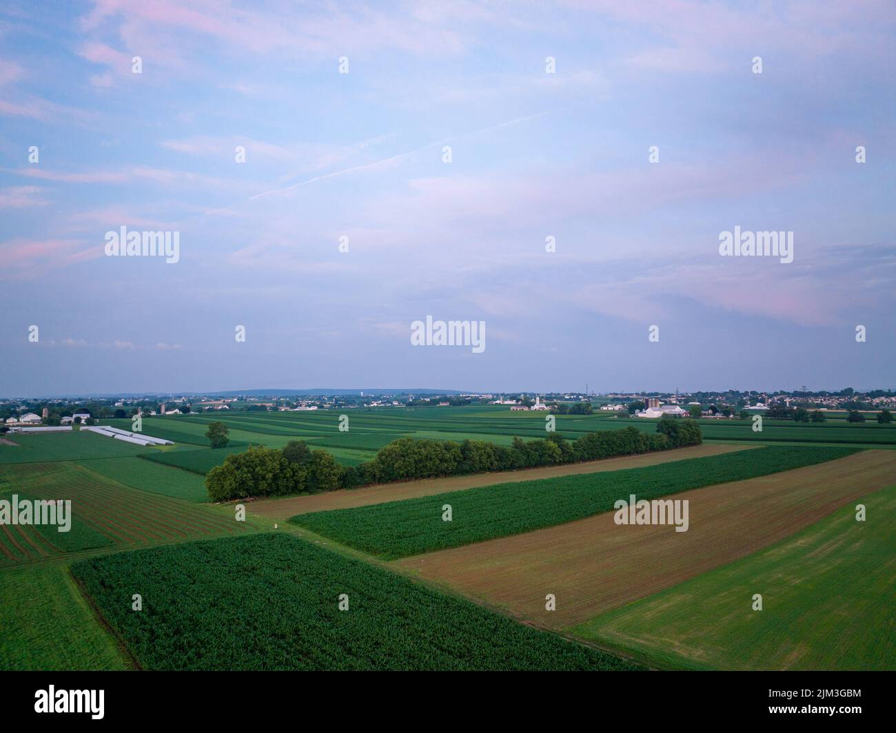 An aerial view of the blue hour over the lush green farmland Stock ...