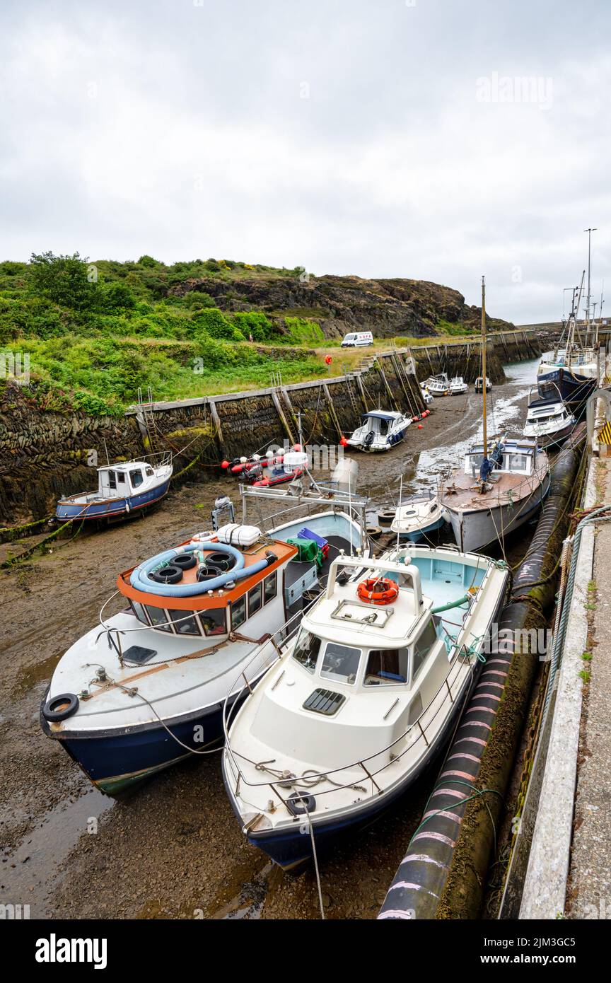 Amlwch, UK- July 8, 2022: Fishing boats moored at Amlch port in North Wales at low tide Stock Photo