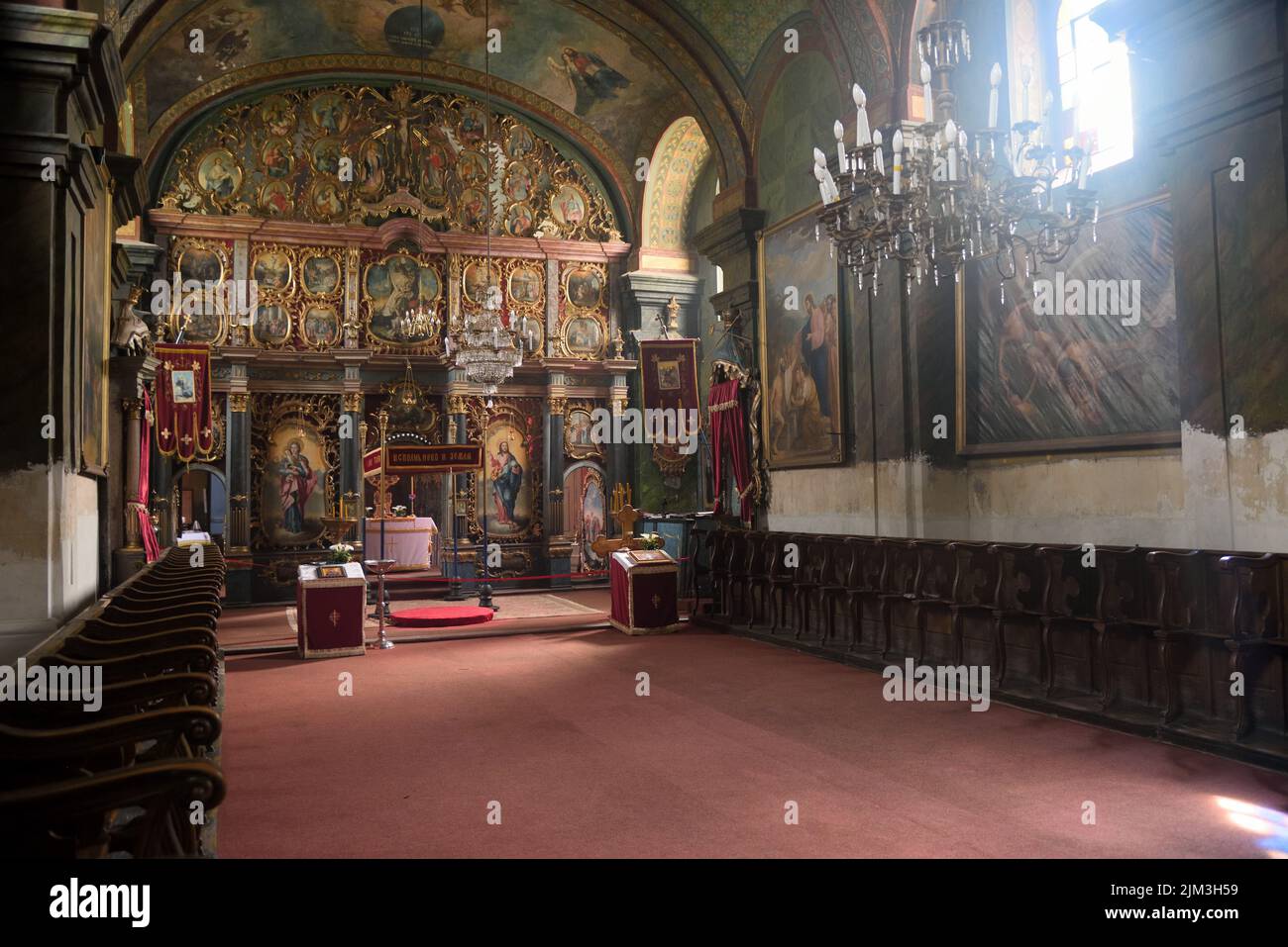 An interior of an empty church rich in religious paintings and