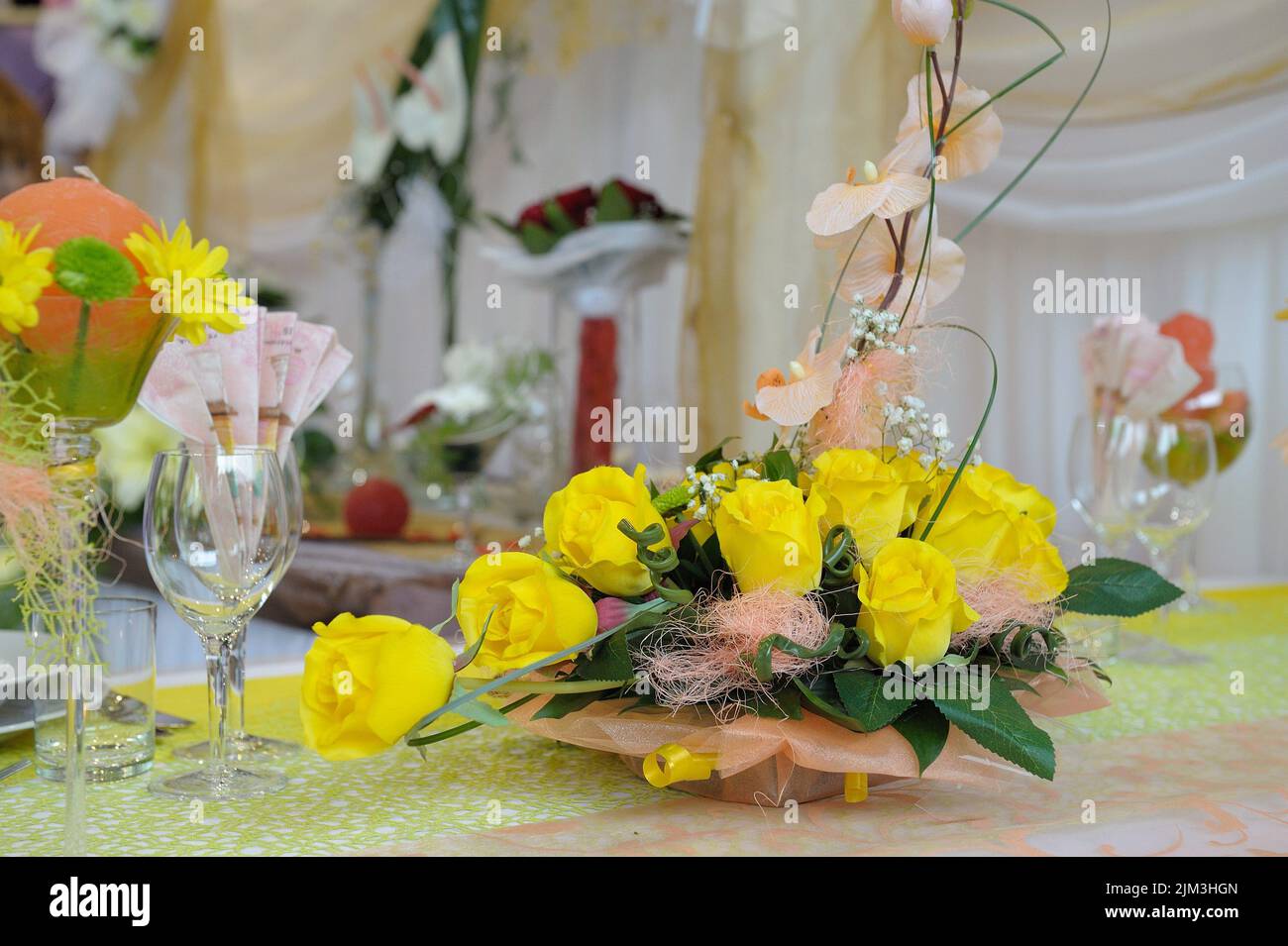 A closeup shot of an elegant table setting with glasses and yellow