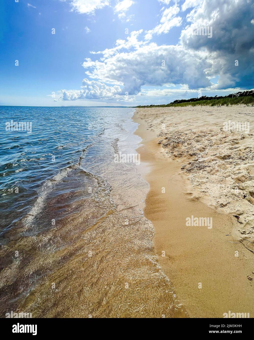 A beautiful view of sandy beach under a cloudy sky Stock Photo - Alamy