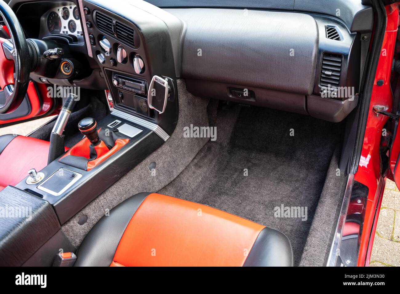 The interior of a mitsubishi eclipse. The colors are red and grey Stock