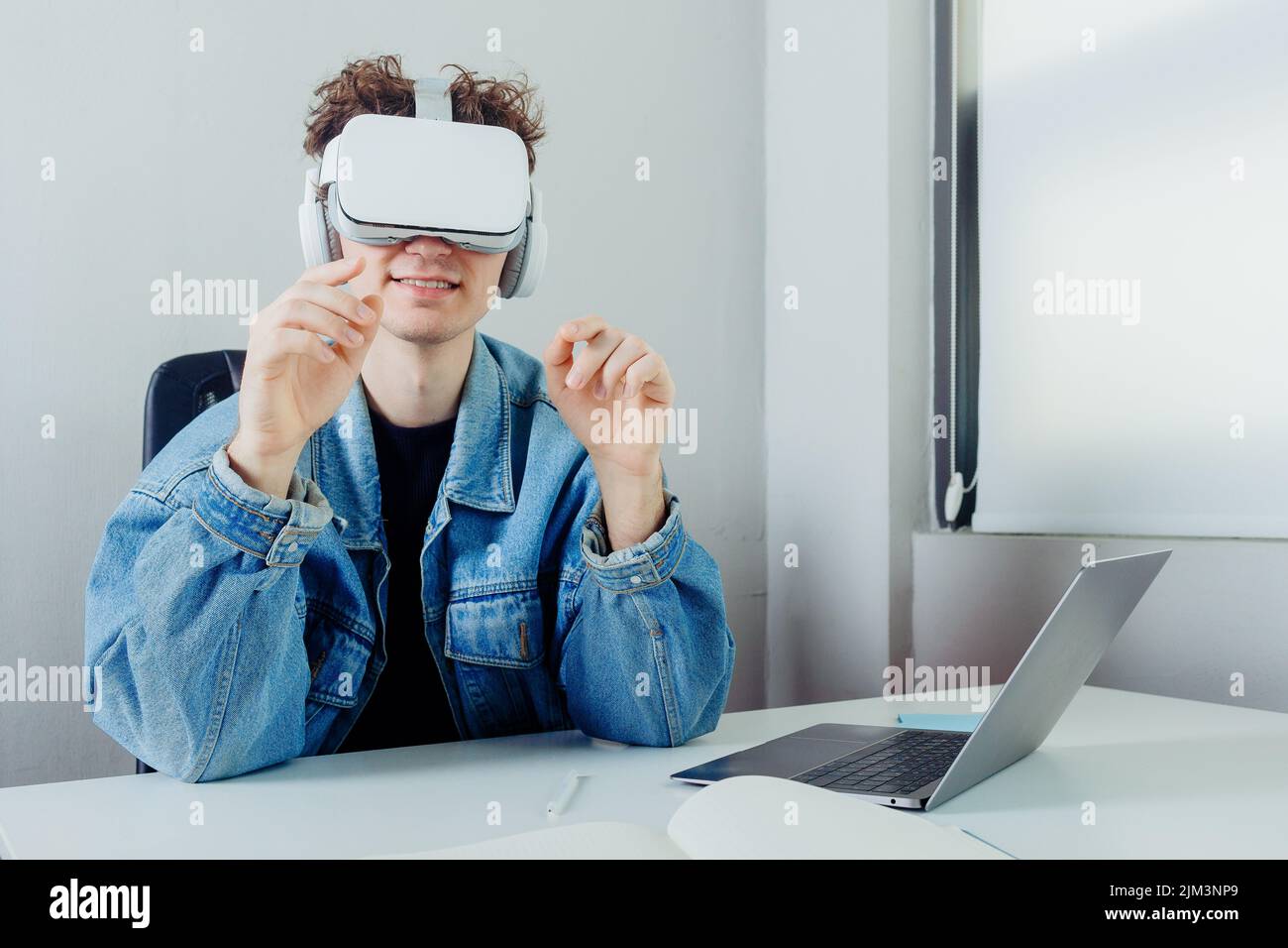 A young handsome freelancer working through VR glasses Stock Photo