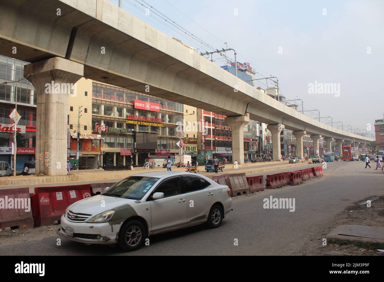 A city view with buildings, cars and metro rail over a street of Dhaka, Bangladesh Stock Photo