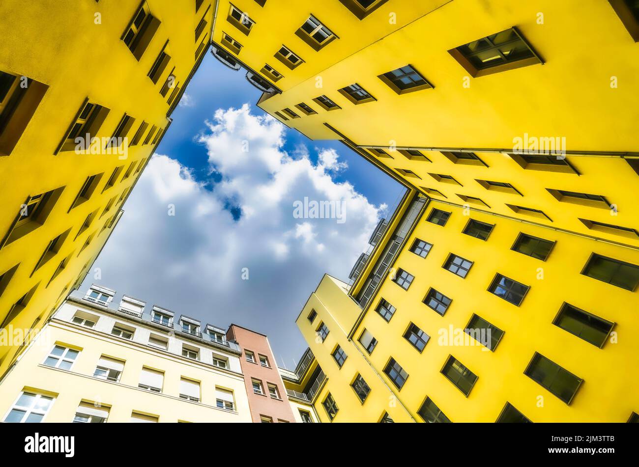 A low angle shot of residential buildings under a cloudy sky Stock ...
