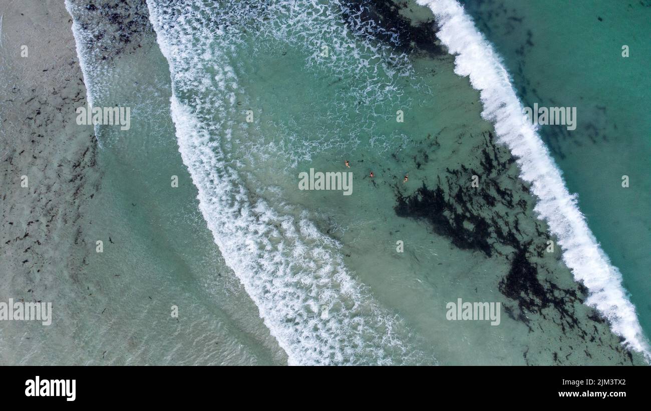 An aerial view of the waves at the beach of Stokes bay in bright sunlight in Kangaroo island, Australia Stock Photo