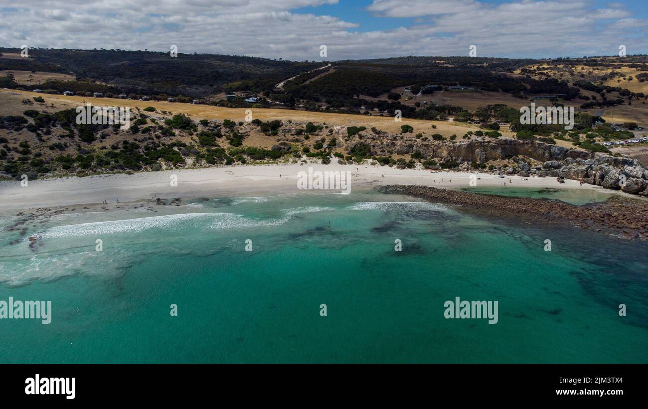 An aerial view of Stokes Bay in bright sunlight against blue cloudy sky at Kangaroo Island, Australia Stock Photo