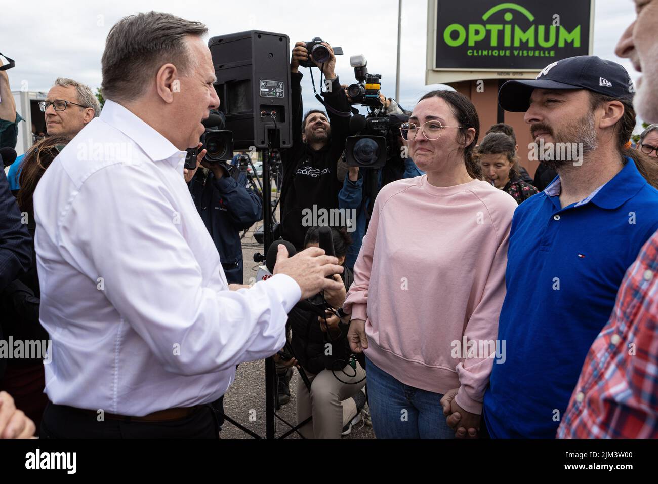 Erika Simard and her partner Charles-David Bergeron-Brisson chat with Quebec Premier Francois Legault following a landslide in the La Baie borough in Stock Photo