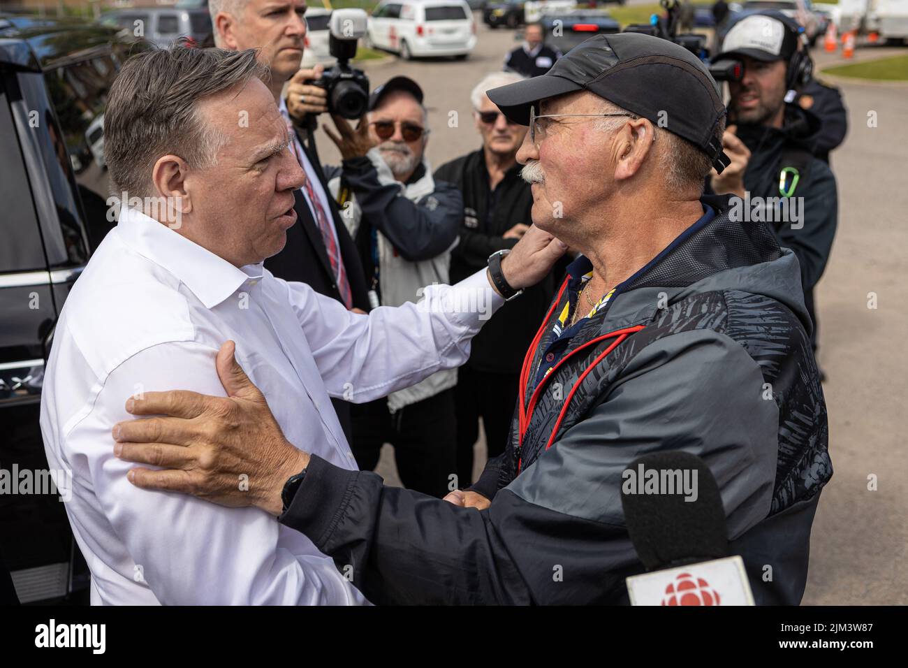 Marius Harvey chats with Quebec Premier Francois Legault following a landslide in the La Baie borough in Saguenay Wednesday June 22, 2022. Stock Photo
