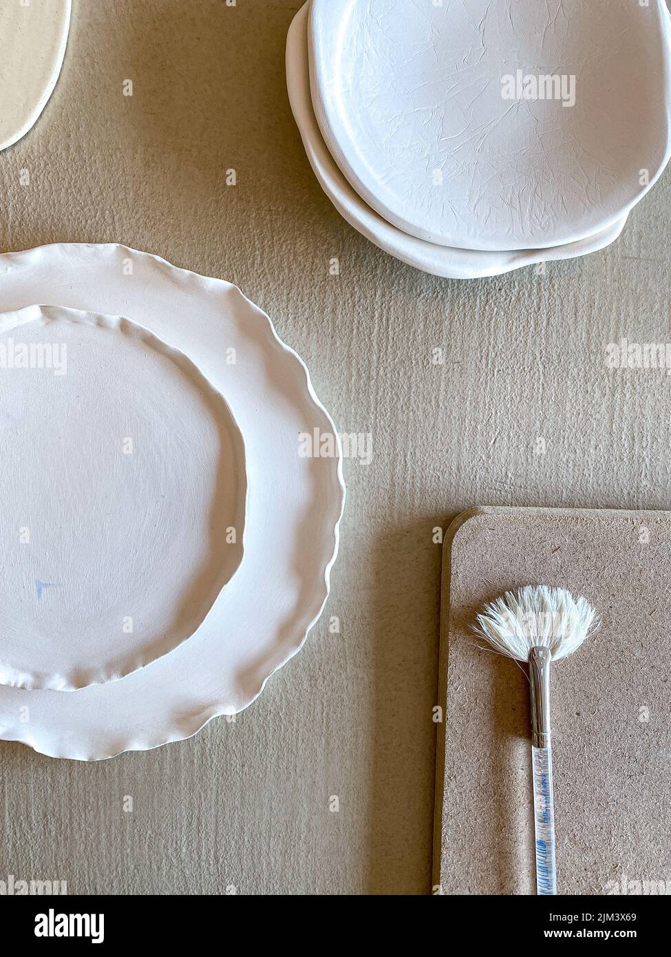 Bisque Fired Ceramics with Glazing Brush in Studio Stock Photo Alamy