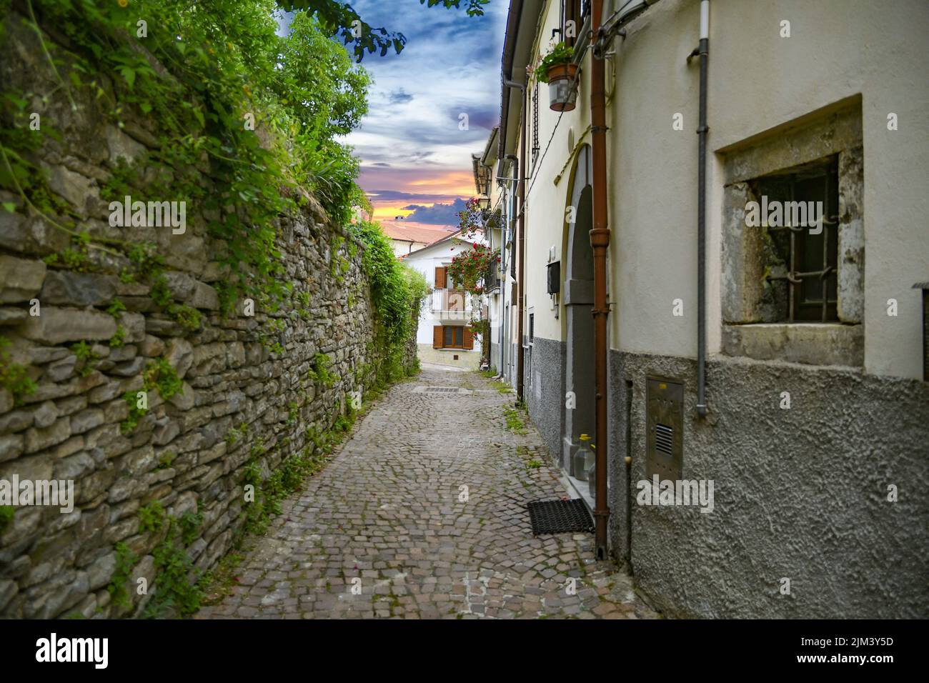 A narrow alley between medieval stone buildings in Agnone - a small village in Molise region, Italy Stock Photo