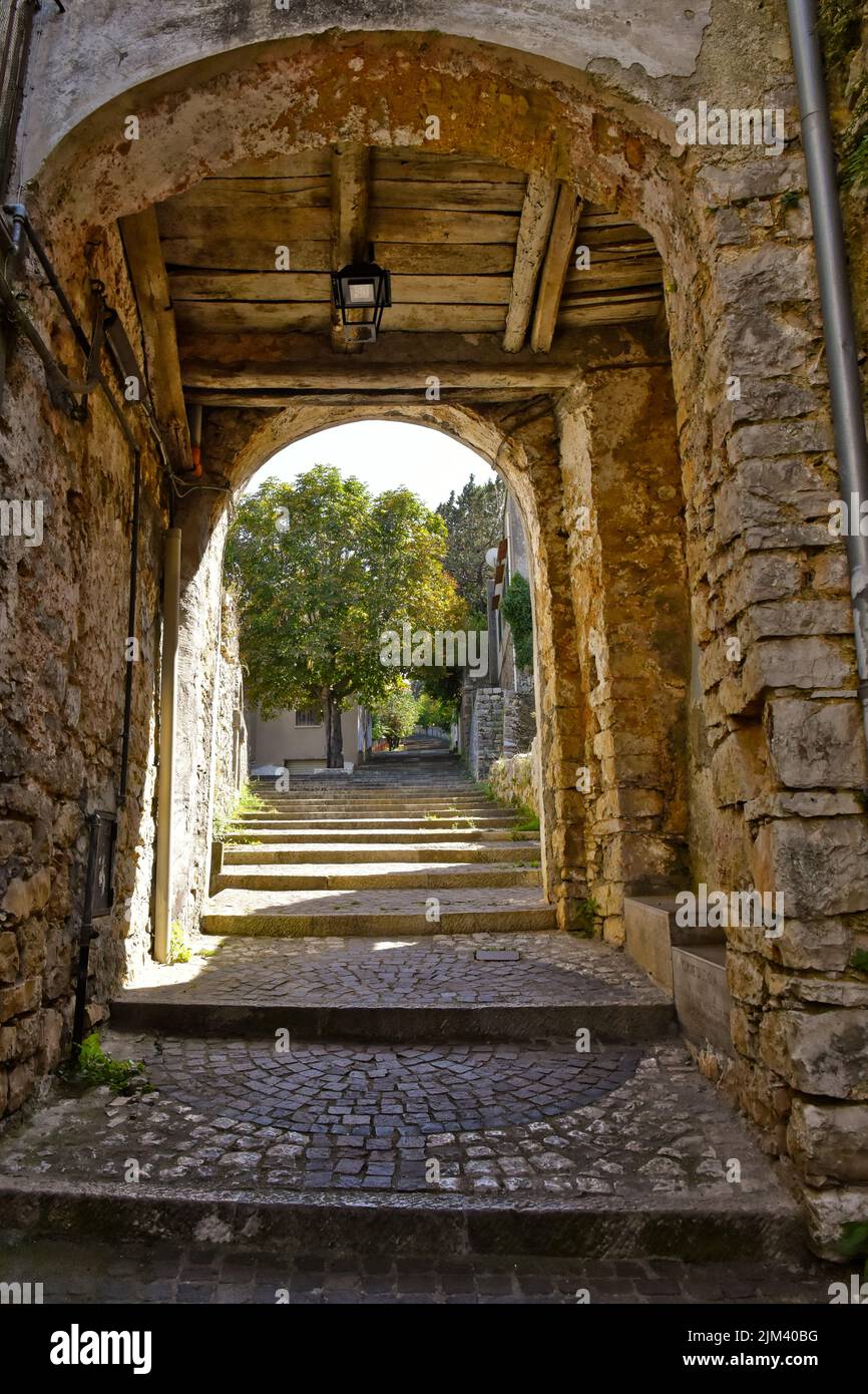 A vertical shot of an old stone arch on the street in Lenola. Province of Latina, Lazio, Italy. Stock Photo