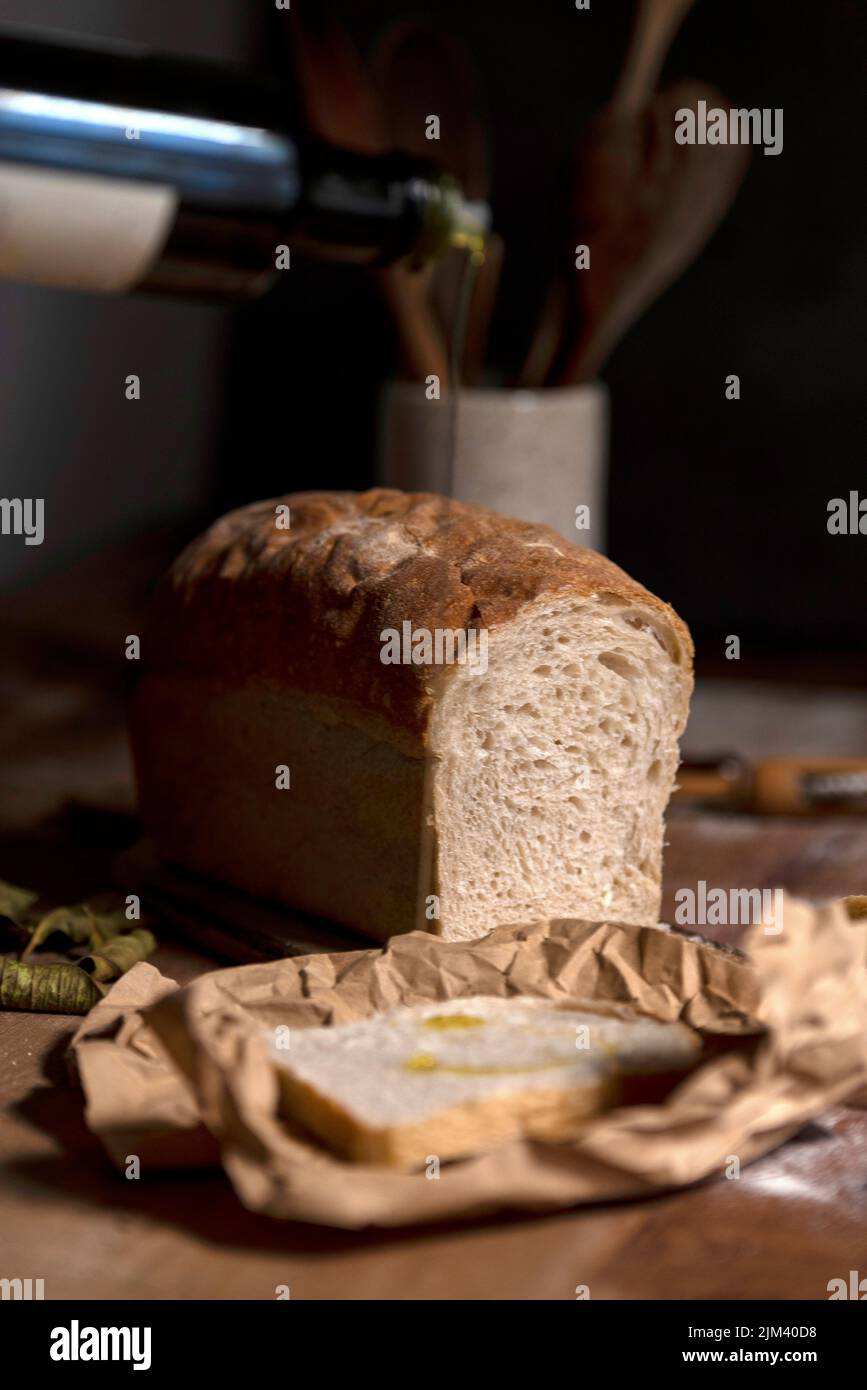 A vertical closeup of homemade sourdough bread with olive oil Stock