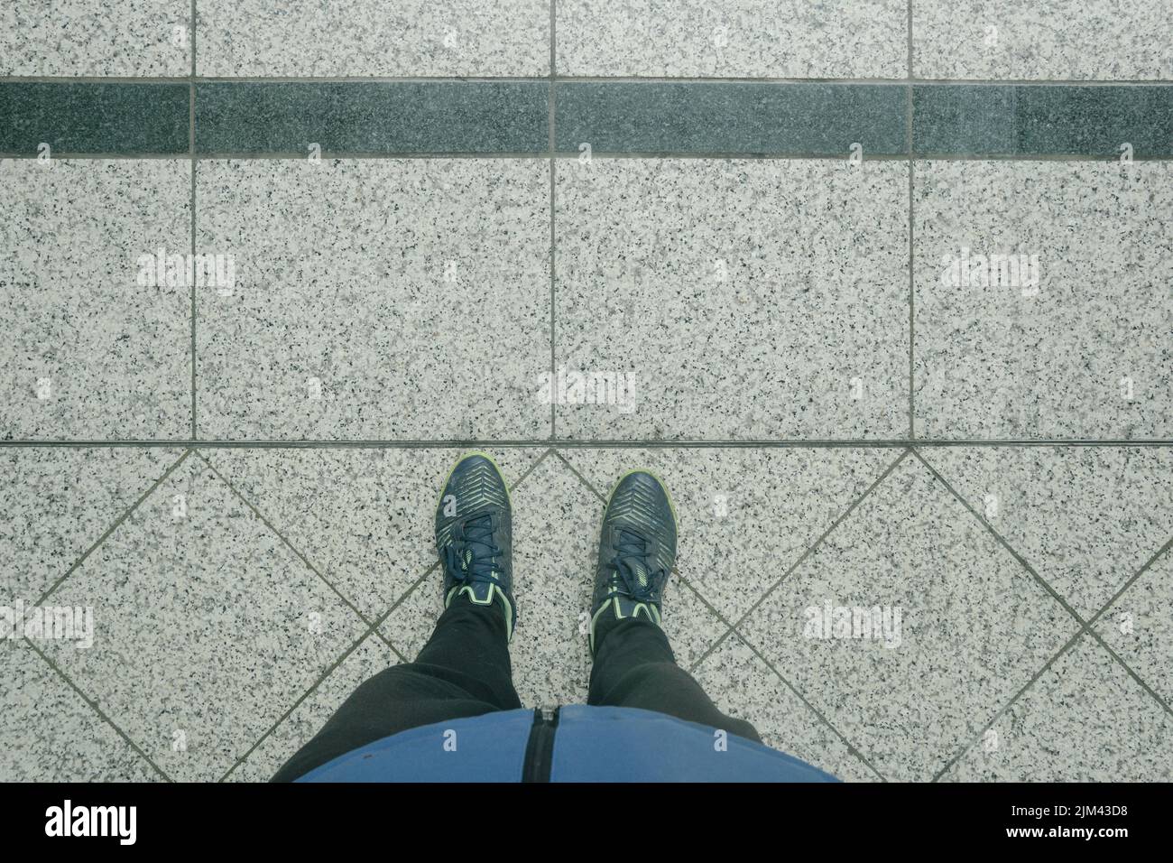 A top view of a person's feet on a concrete ground Stock Photo Alamy