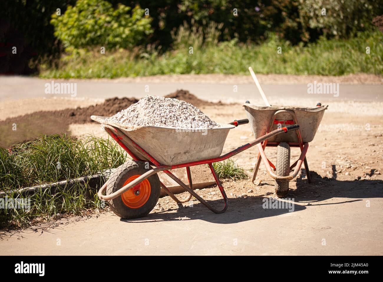 Wheelbarrow with gravel at the construction site Stock Photo Alamy