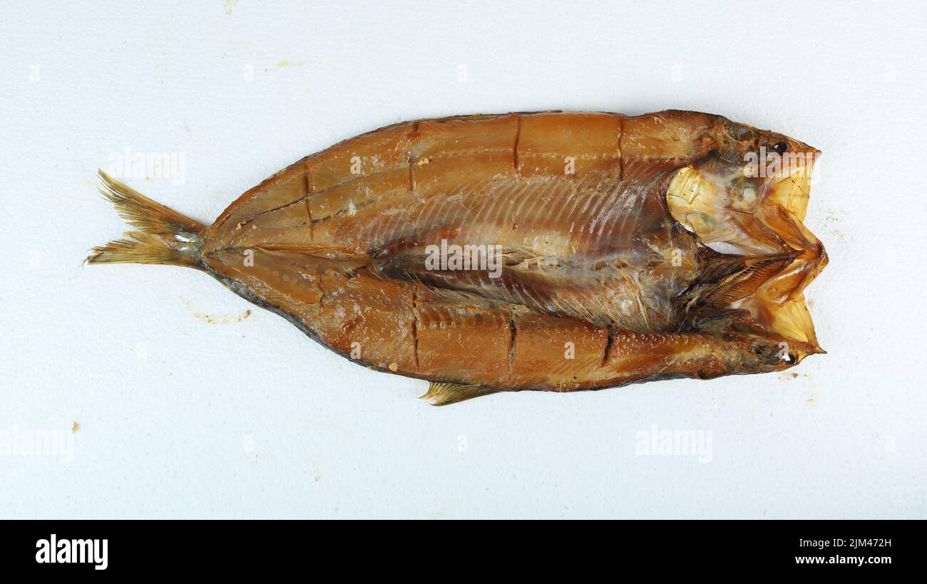 A large smoked Kipper fish isolated on a white background Stock Photo