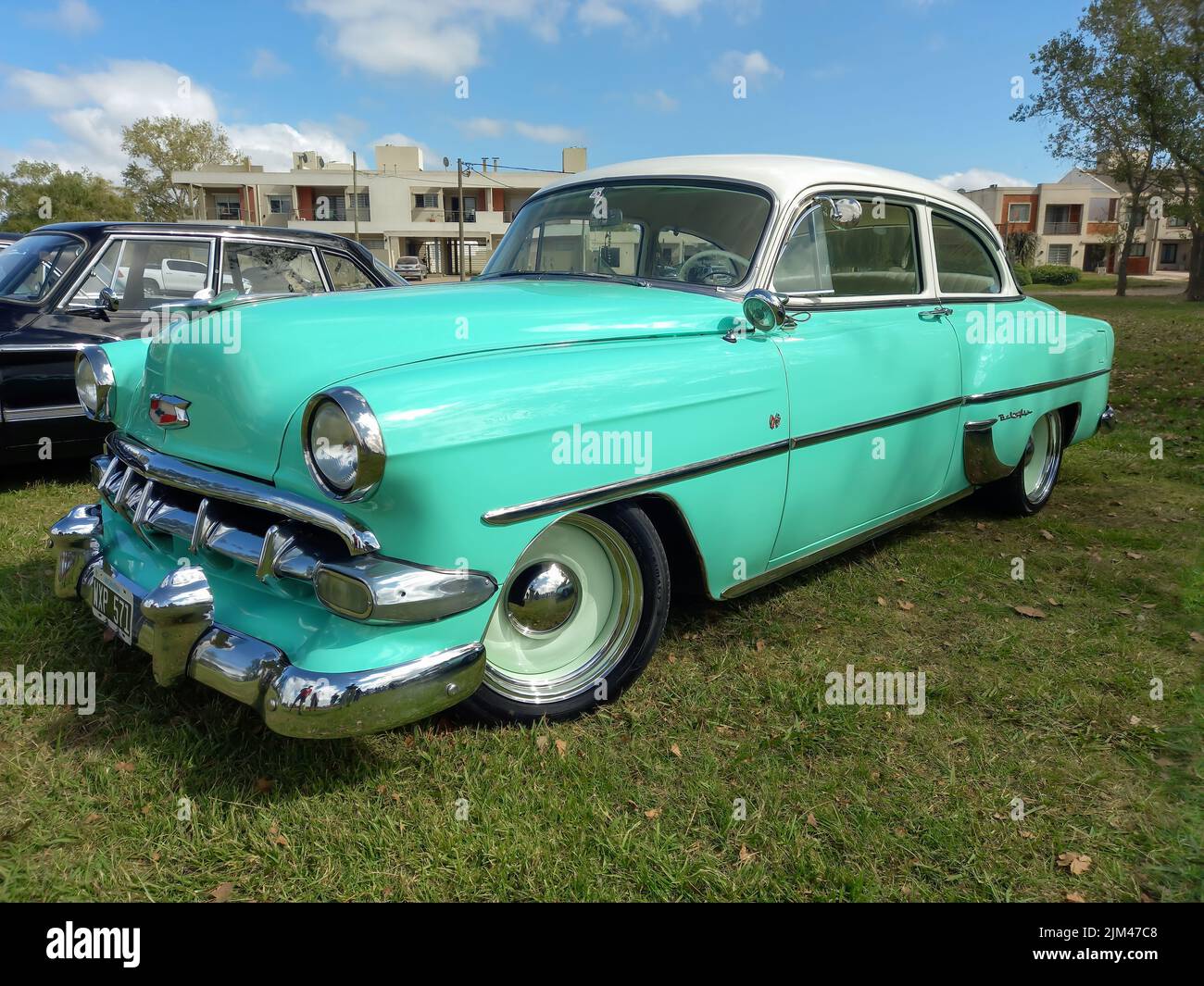 Old cyan Chevrolet Chevy Bel Air coupe hardtop two door early 1950s parked on the grass. Nature. Classic car show. Copyspace Stock Photo