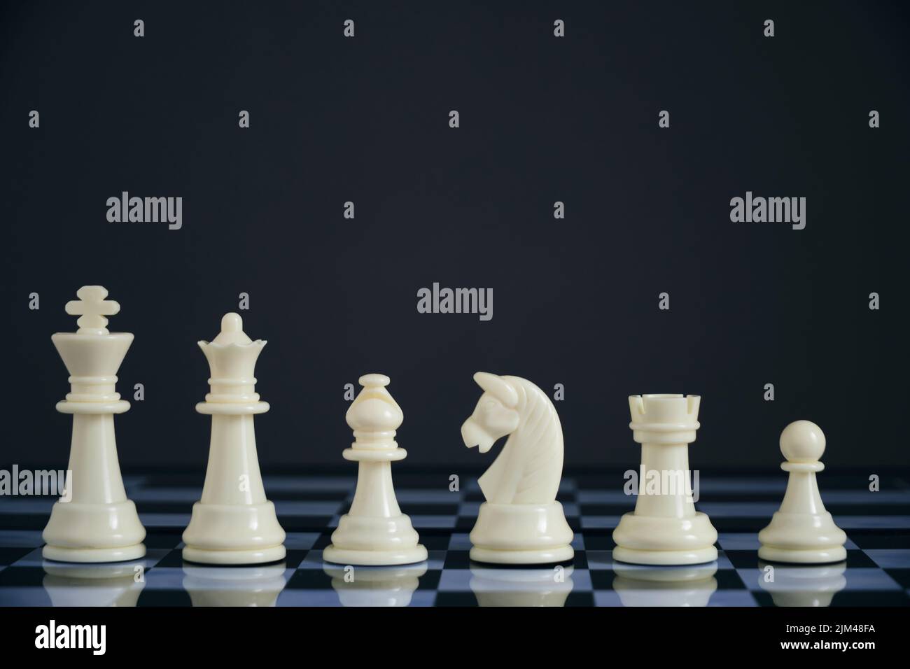 All suits white chess pieces on chess board Stock Photo - Alamy
