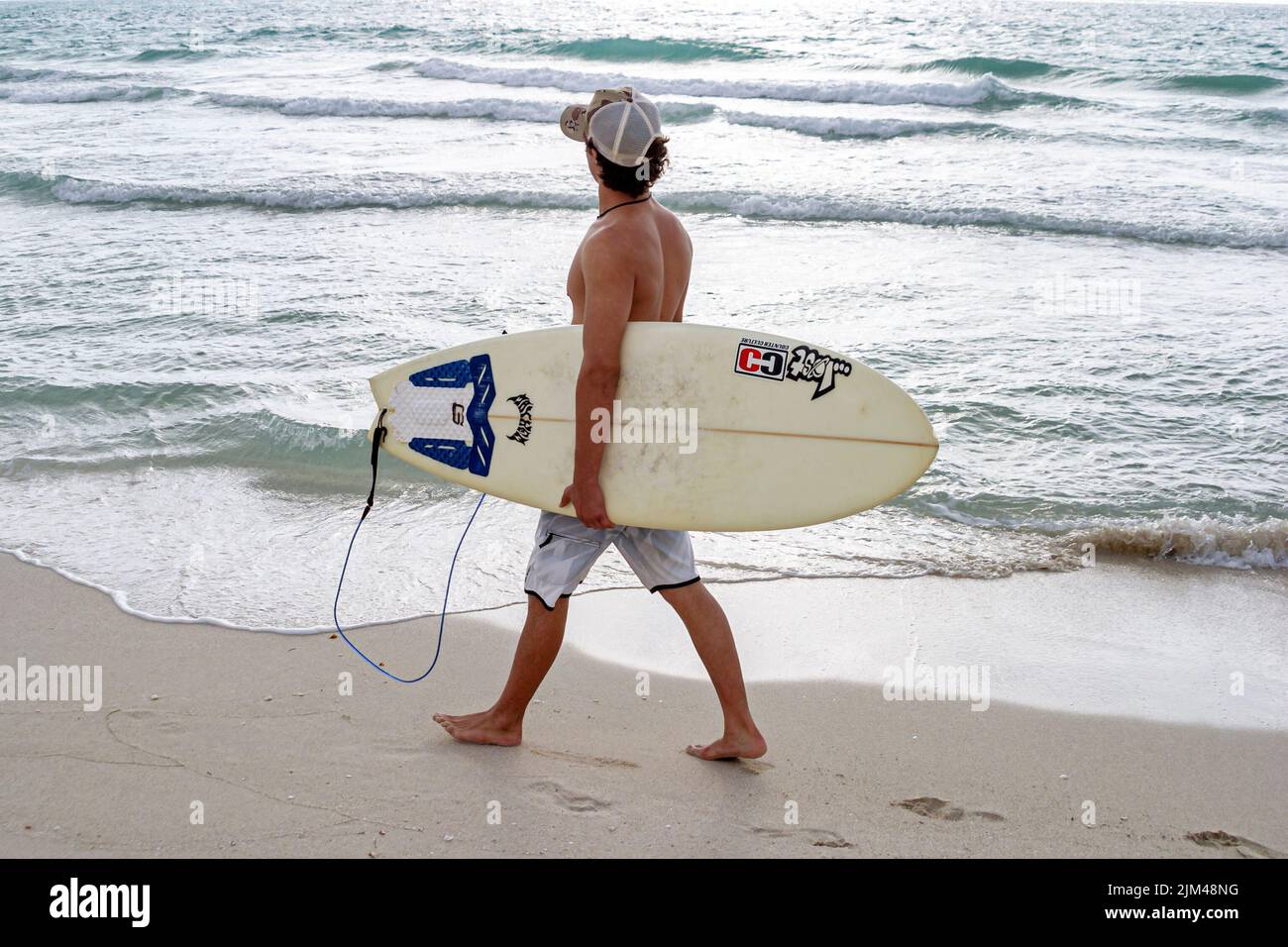 Miami Beach Florida,Atlantic Ocean shore shoreline surf waves water coast coastline public,surfer man men male carrying surfboard looking Stock Photo