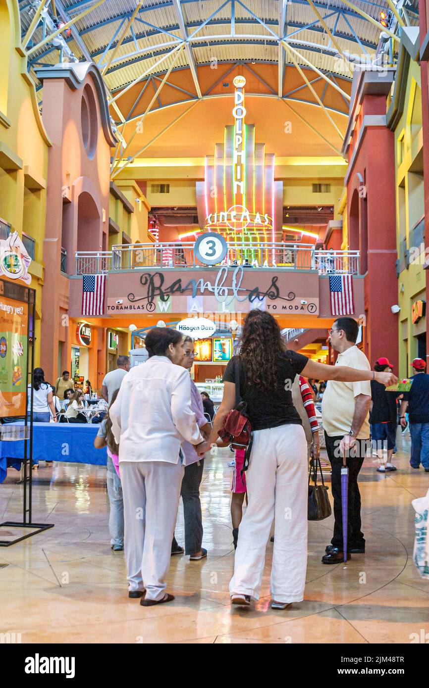 Miami Florida,Dolphin Mall Cinema neon sign,inside interior shoppers shopping visitors,group people person scene in a photo,USA US Stock Photo