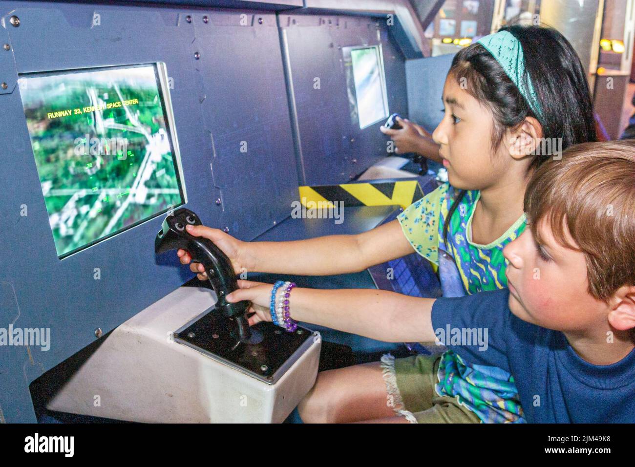 Hampton Virginia,Tidewater Area,Virginia Air and Space Center centre inside interior,collection exhibit,Asian girl boy looking at monitor,visitors Stock Photo
