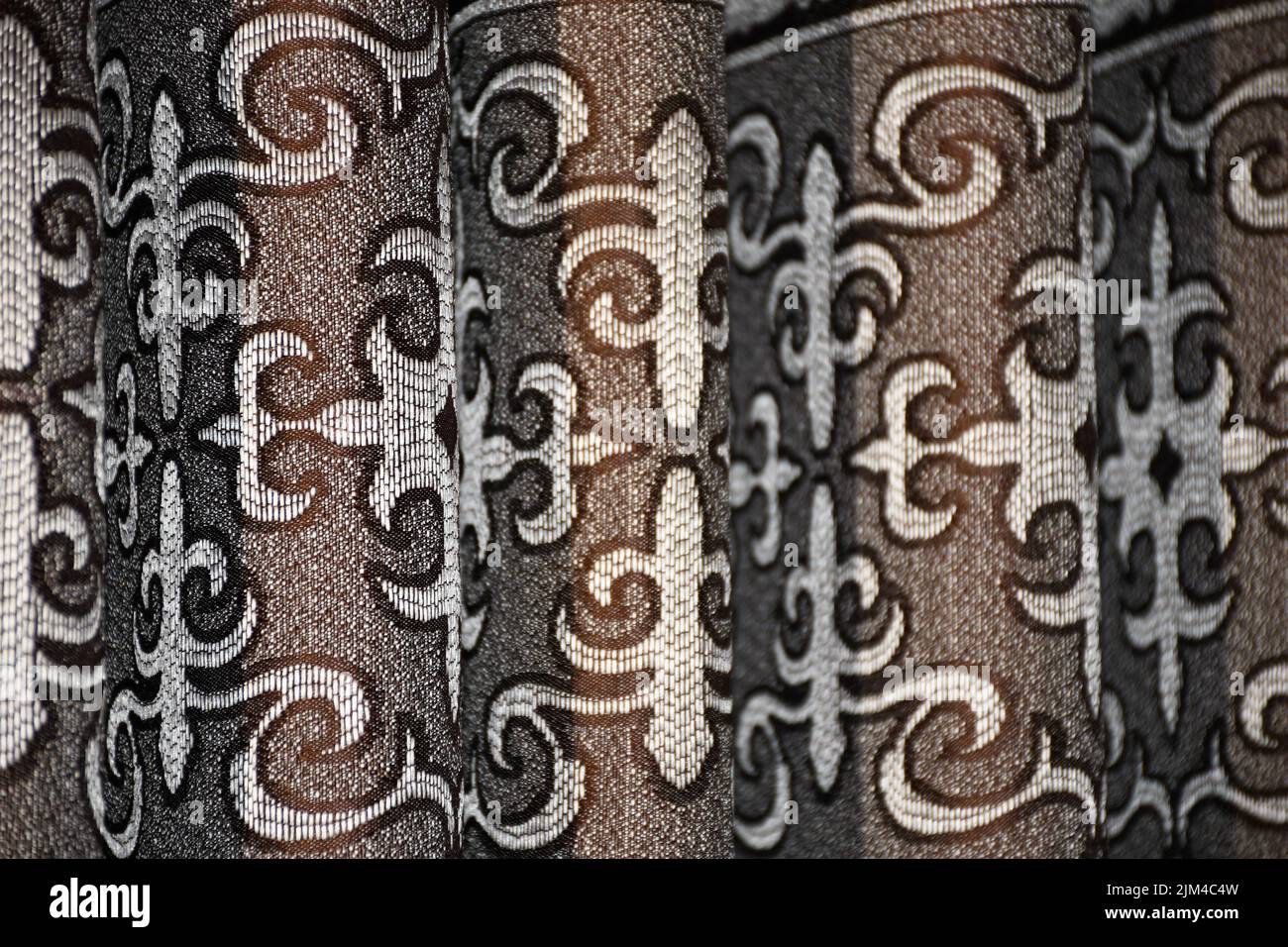 A closeup of a textile made of tiny beads creating an intricate design ...