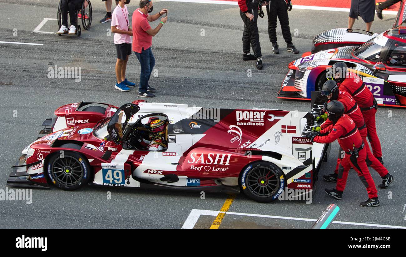 A closeup of sports cars on track with many people during motor Sports at the Dubai Autodrome Stock Photo