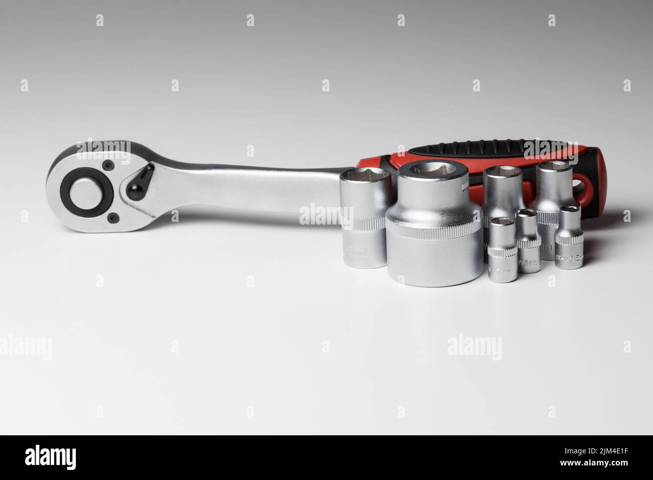 Ratchet wrench with hex socket and several interchangeable sockets of