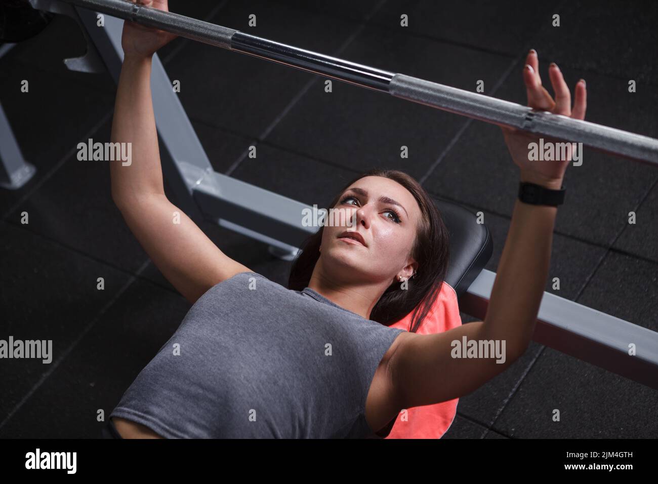 Top view cropped shot of a beautiful young sportswoman preparing for barbell bench press exercisr Stock Photo