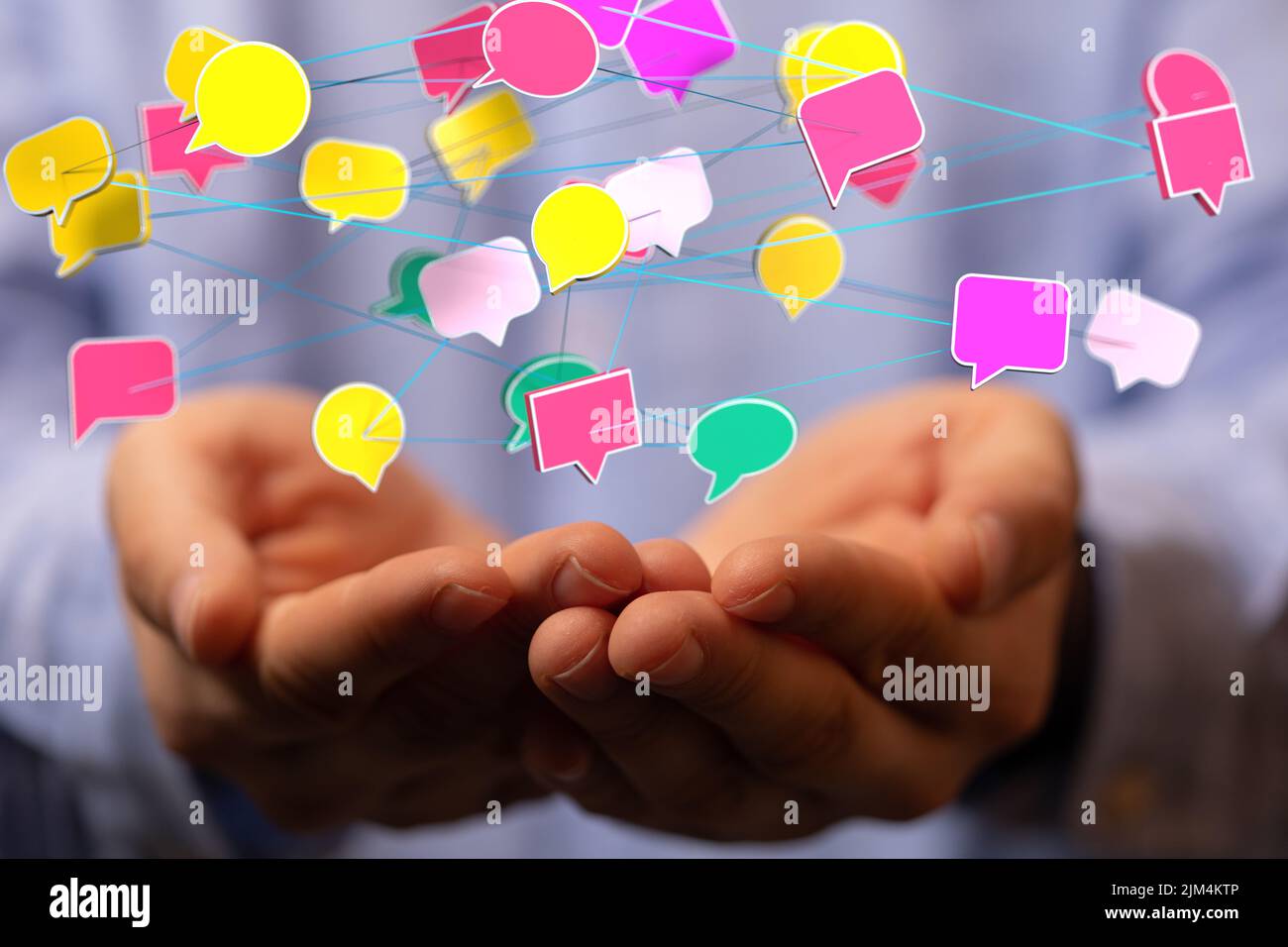 A person's hand with illustrative message icons floating above hands