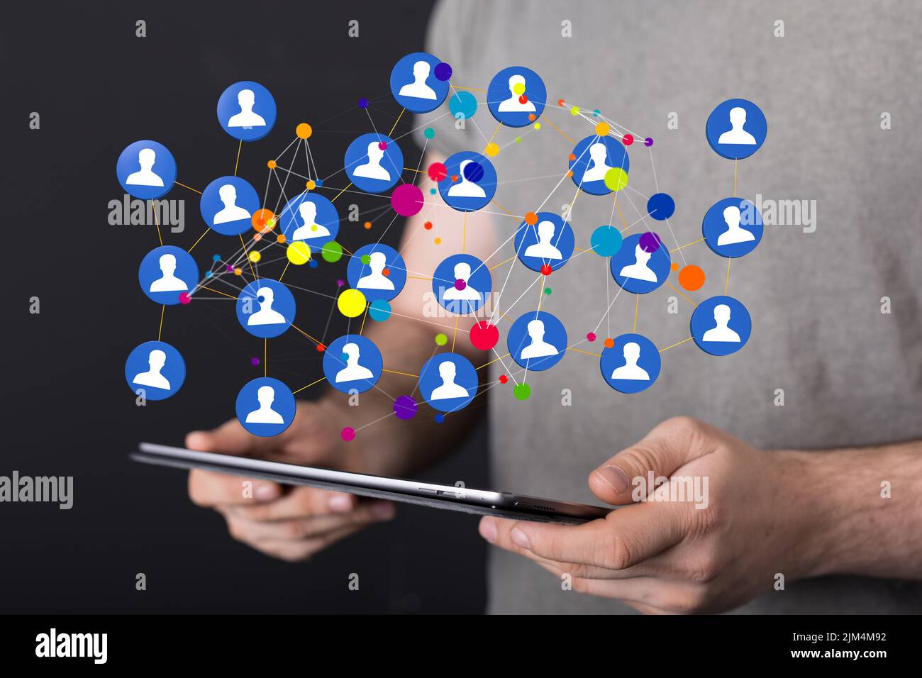 A 3D rendering of profile icons levitating above a tablet in a person's ...